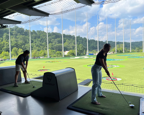 Young contractors golfing at Top Golf