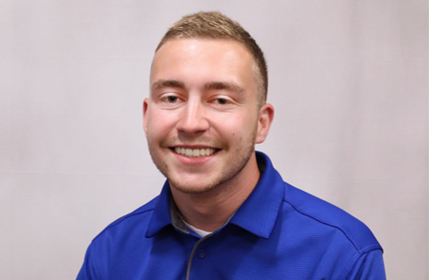 Young man headshot in blue polo shirt