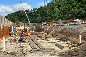 Space can be tight as the team works between the river and the hillside, approximately 10 feet below river grade